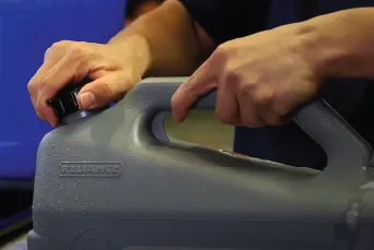 Hands screwing cap on reusable water container